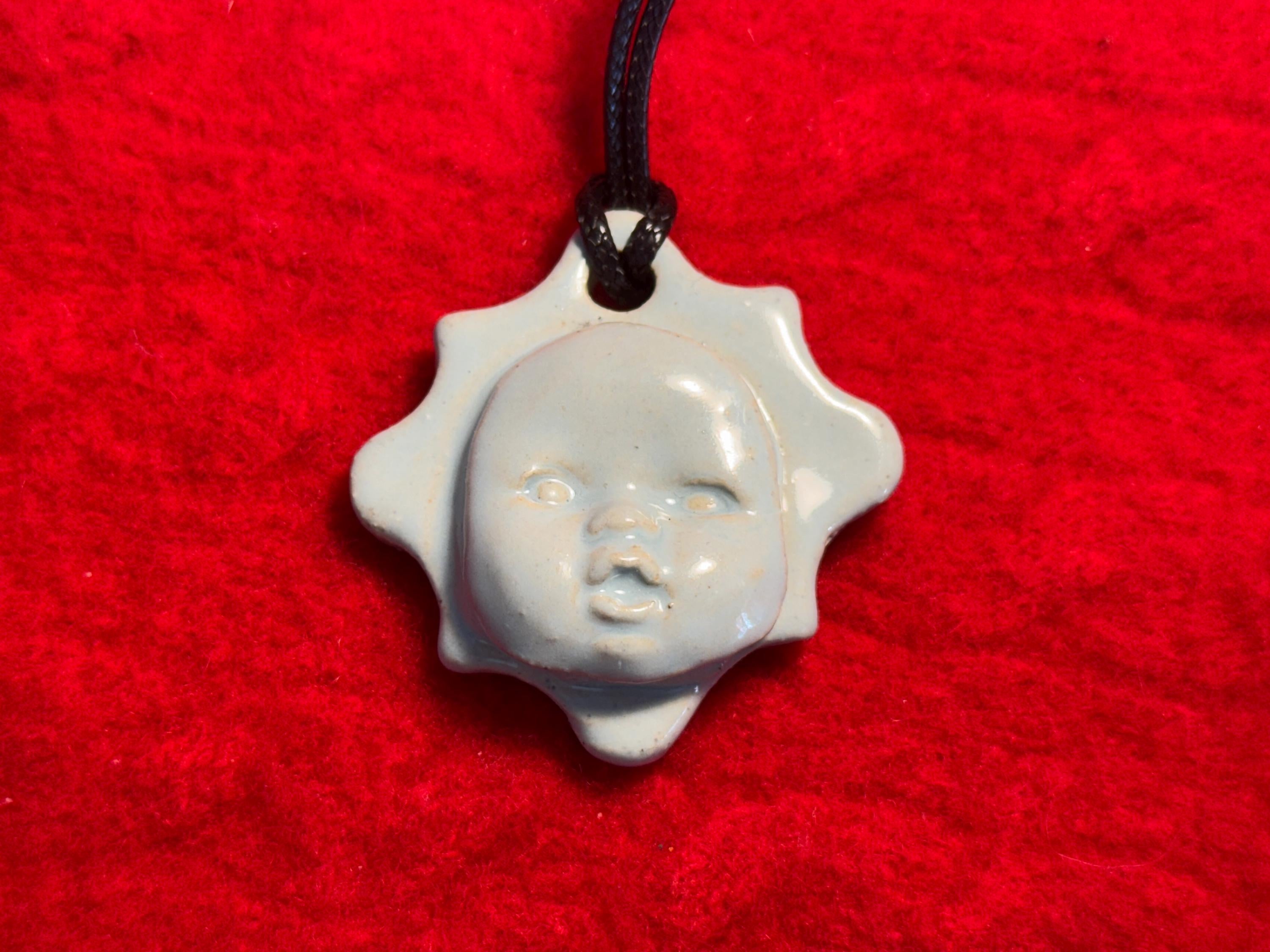 baby face necklace - baby blue