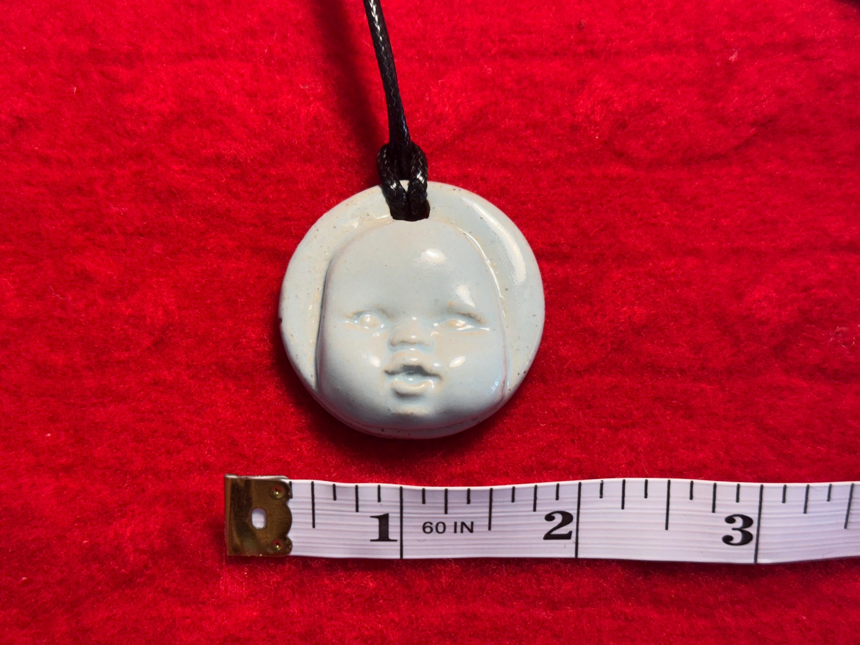 baby face necklace - baby blue