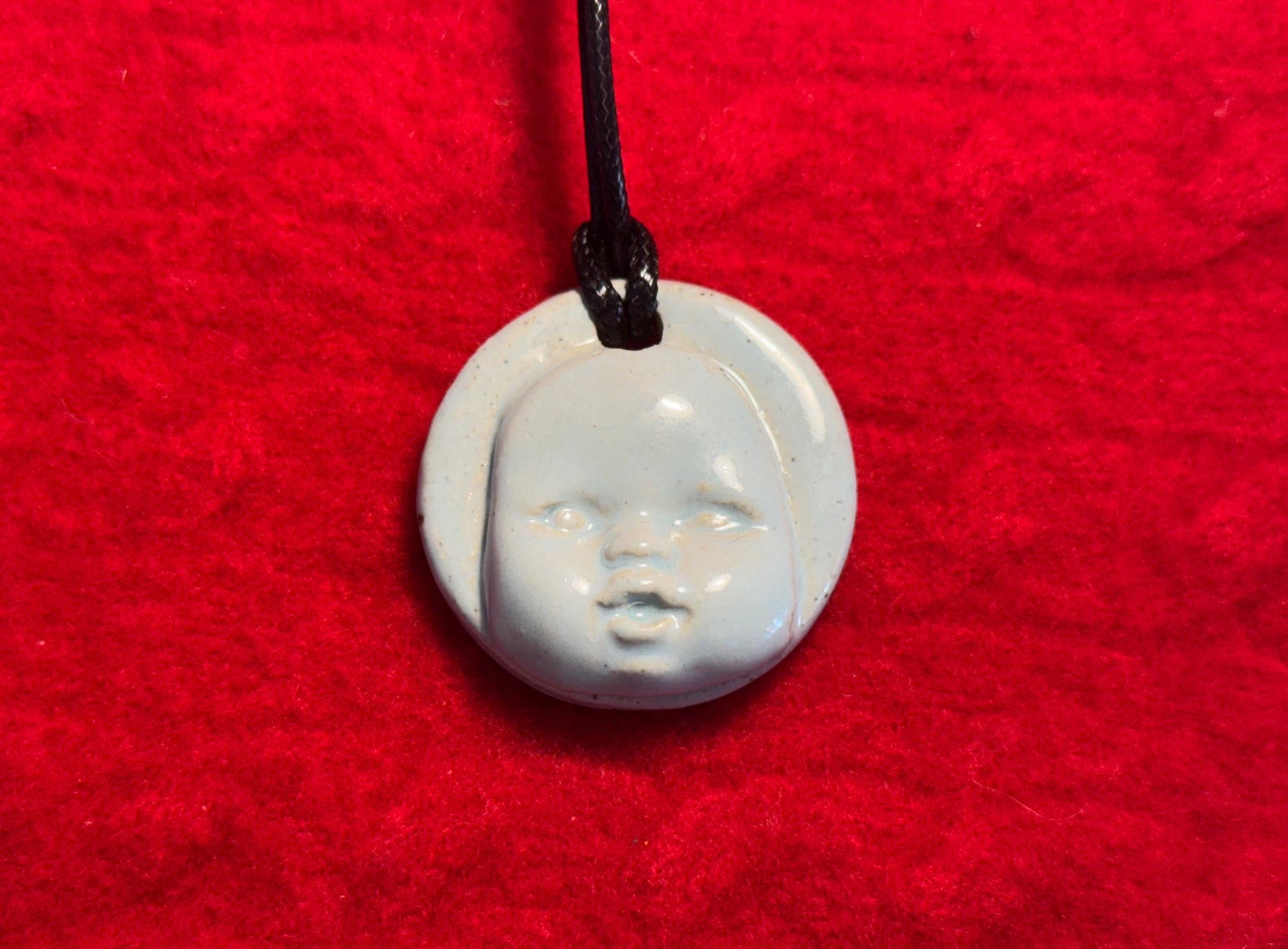 baby face necklace - baby blue