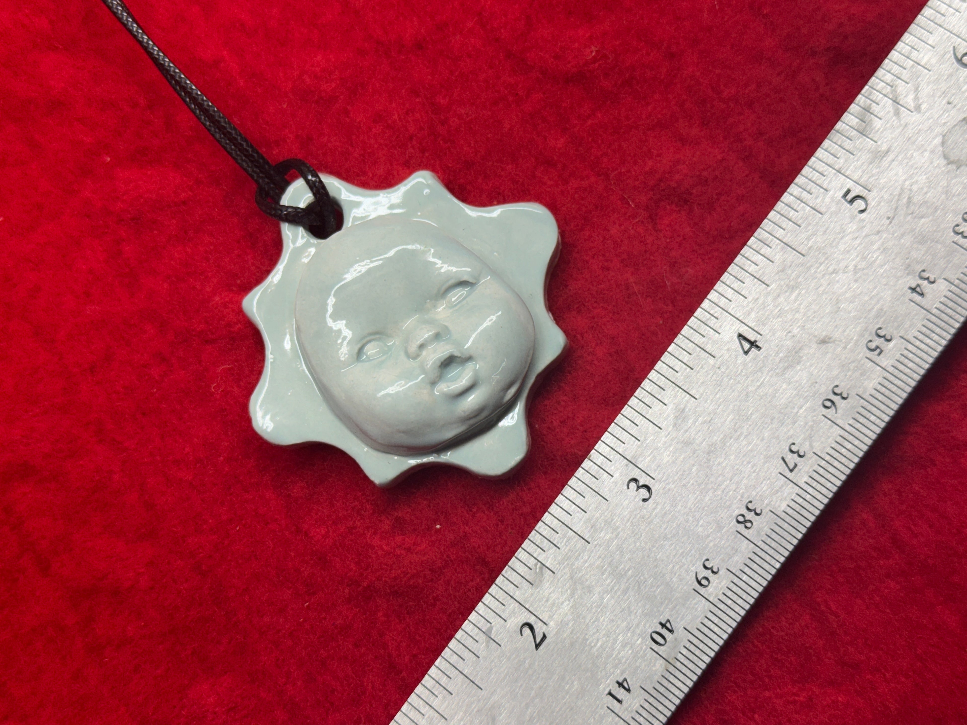 baby face necklace - baby blue
